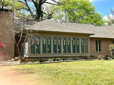 Sunroom addition with wall of windows